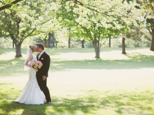 bride and groom underneath a tree
