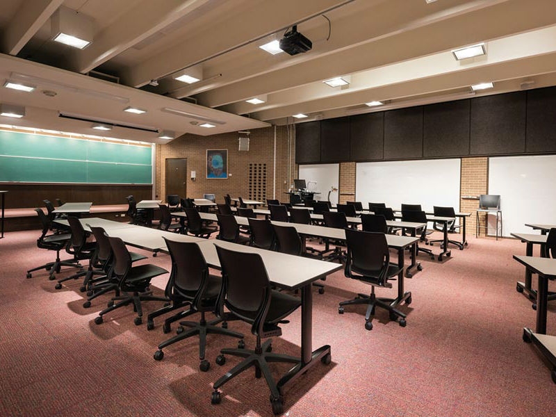 Classroom (Todd Wehr 104) with desks, chairs and whiteboard
